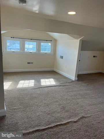 a view of wooden floor and windows in a room