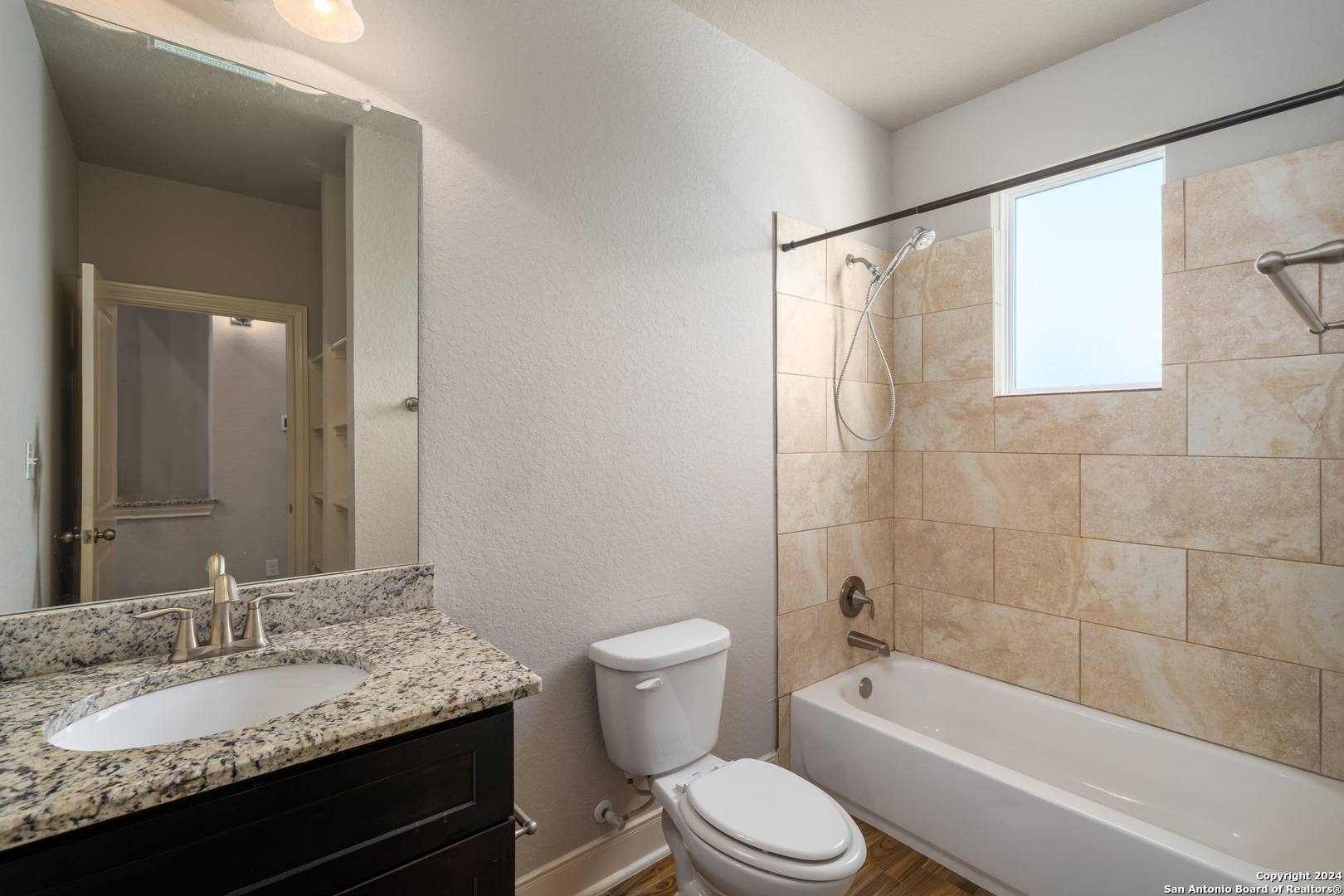 3067 View Ridge Drive, Unit 7 Spring Branch, TX 78070 - Photo 11 of 21 a bathroom with a granite countertop sink toilet and shower