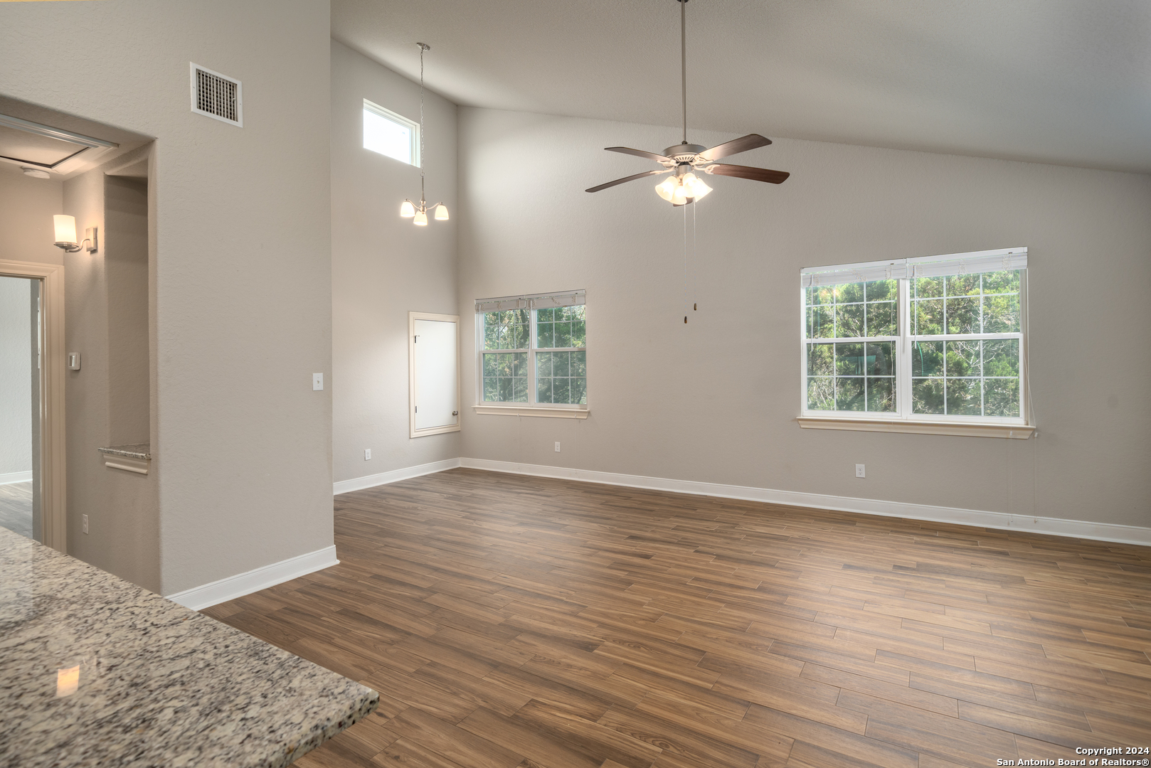 3067 View Ridge Drive, Unit 7 Spring Branch, TX 78070 - Photo 12 of 21 a view of an empty room with wooden floor and a window