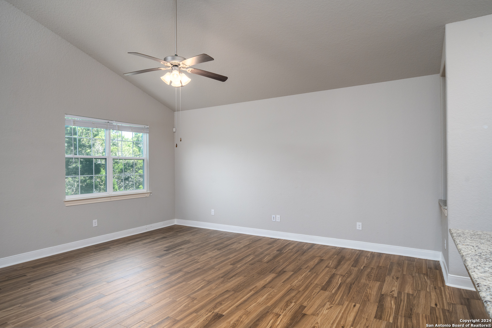 3067 View Ridge Drive, Unit 7 Spring Branch, TX 78070 - Photo 15 of 21 wooden floor in an empty room with a window