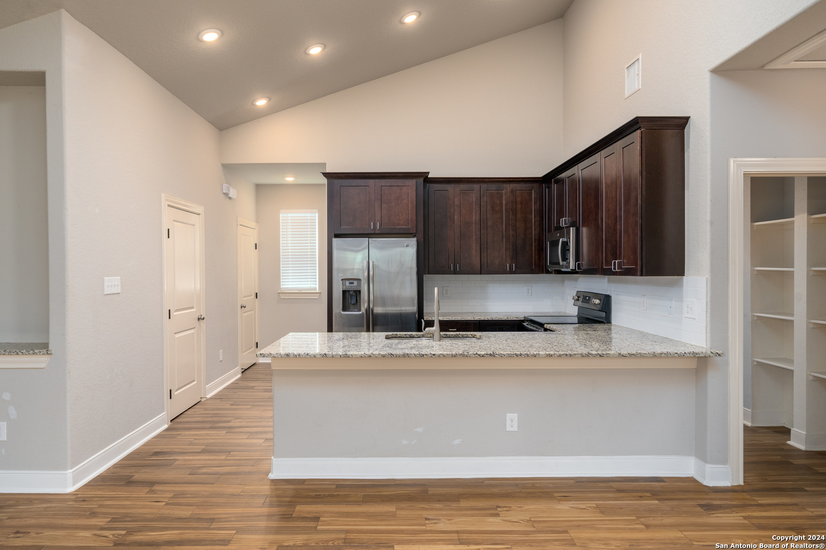 3067 View Ridge Drive, Unit 7 Spring Branch, TX 78070 - Photo 9 of 21 a view of cabinets a sink and dishwasher with wooden floor