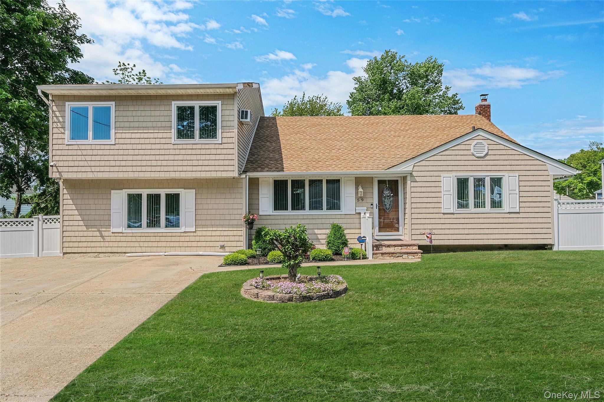 59 Maybrook Road North Babylon, NY 11703 - Photo 1 of 43 a front view of a house with a garden and yard