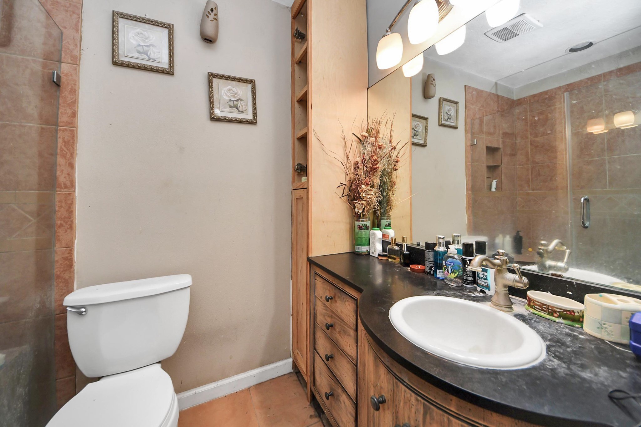 6719 Rubilee Avenue Humble, TX 77396 - Photo 13 of 23 a bathroom with a granite countertop toilet sink and mirror