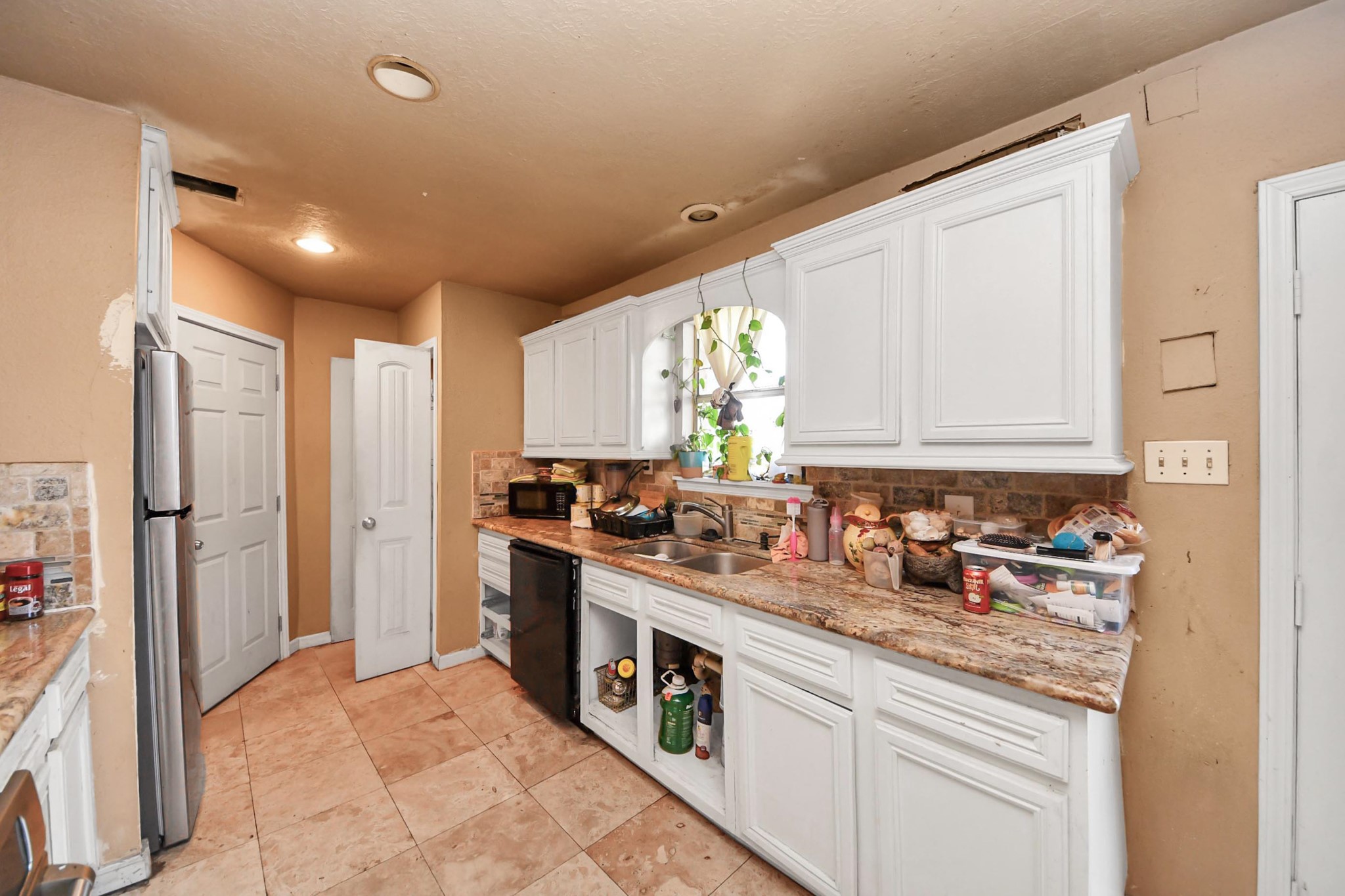 6719 Rubilee Avenue Humble, TX 77396 - Photo 3 of 23 a kitchen with stainless steel appliances granite countertop a refrigerator and a sink