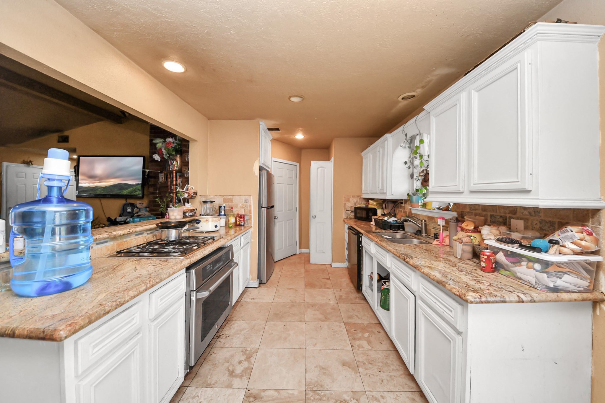 6719 Rubilee Avenue Humble, TX 77396 - Photo 4 of 23 a large kitchen with stainless steel appliances granite countertop a stove and a sink