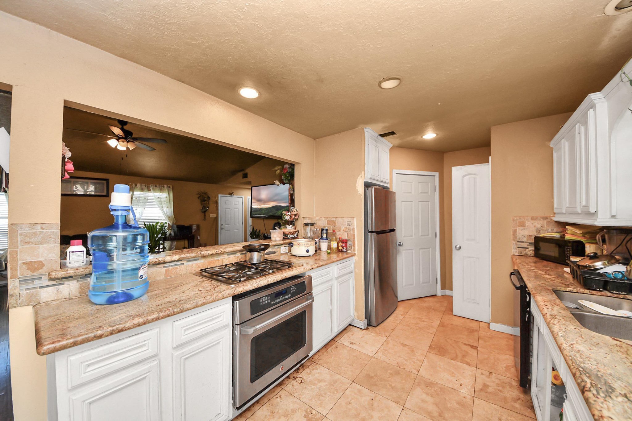 6719 Rubilee Avenue Humble, TX 77396 - Photo 5 of 23 a kitchen with stainless steel appliances granite countertop a sink stove and refrigerator