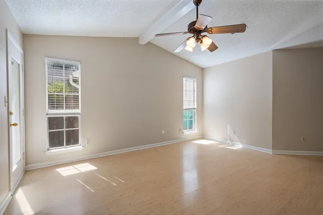 a view of an empty room with a window