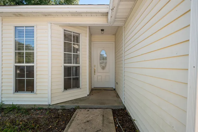 a front view of a house with white walls