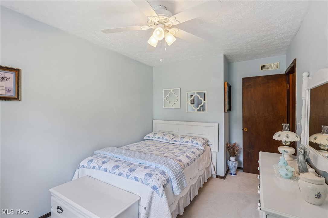 6130 Warren - Sharon Road Brookfield, OH 44403 - Photo 22 of 50 Bedroom #2 featuring light carpet, a textured ceiling, and ceiling fan