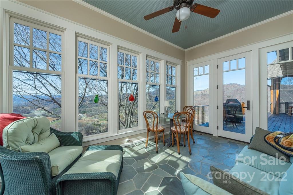 1116 Glades Road Clyde, NC 28721 - Photo 16 of 48 a living room with furniture and a floor to ceiling window
