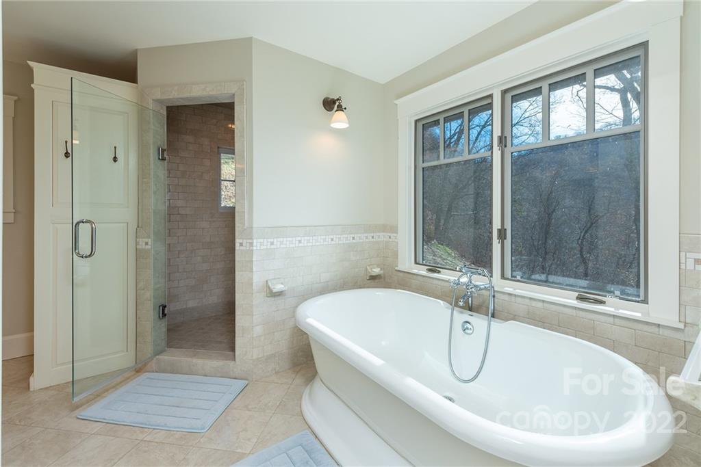 1116 Glades Road Clyde, NC 28721 - Photo 22 of 48 a white bath tub sitting next to a bathroom