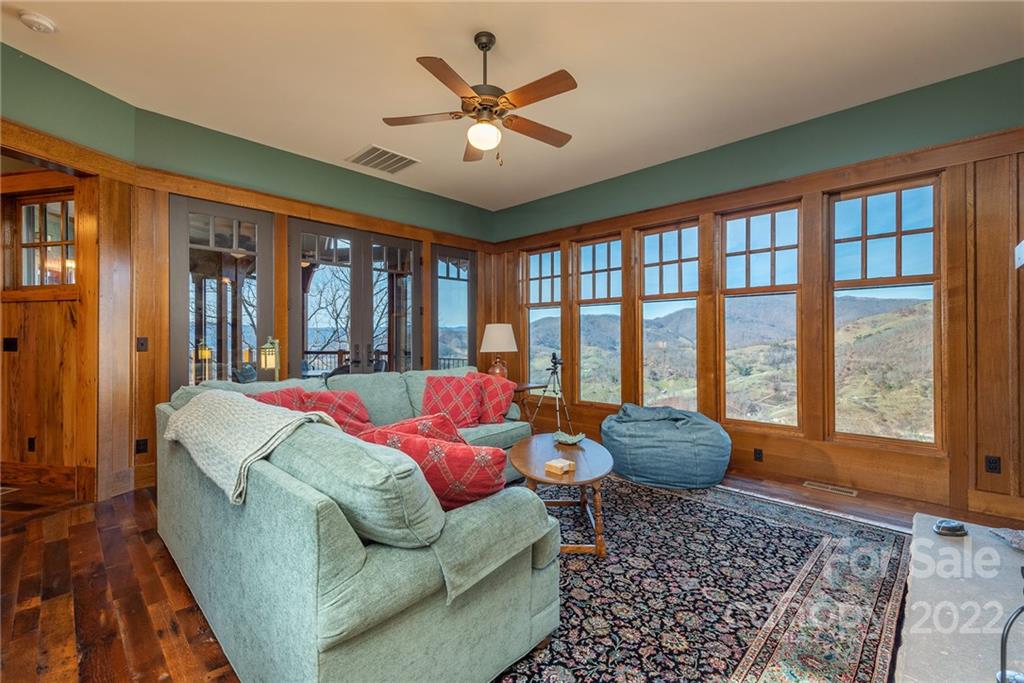 1116 Glades Road Clyde, NC 28721 - Photo 28 of 48 a living room with furniture and a large window with wooden floor