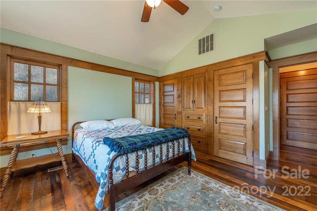 1116 Glades Road Clyde, NC 28721 - Photo 31 of 48 a bedroom with a bed and a chandelier