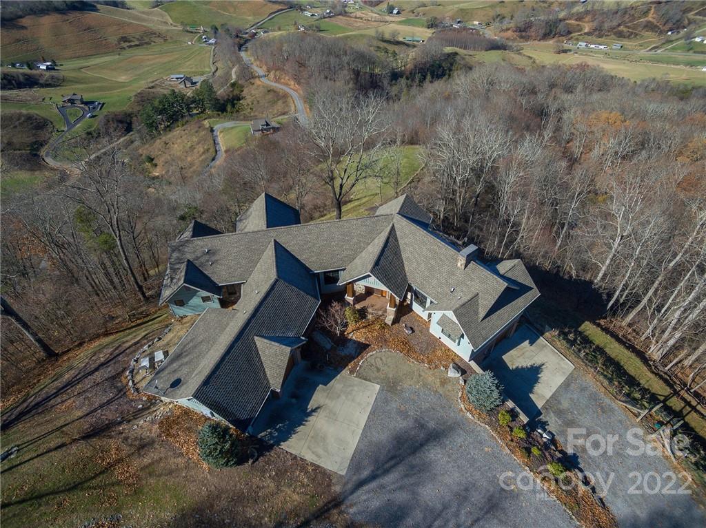 1116 Glades Road Clyde, NC 28721 - Photo 46 of 48 an aerial view of a house with a yard and lake view