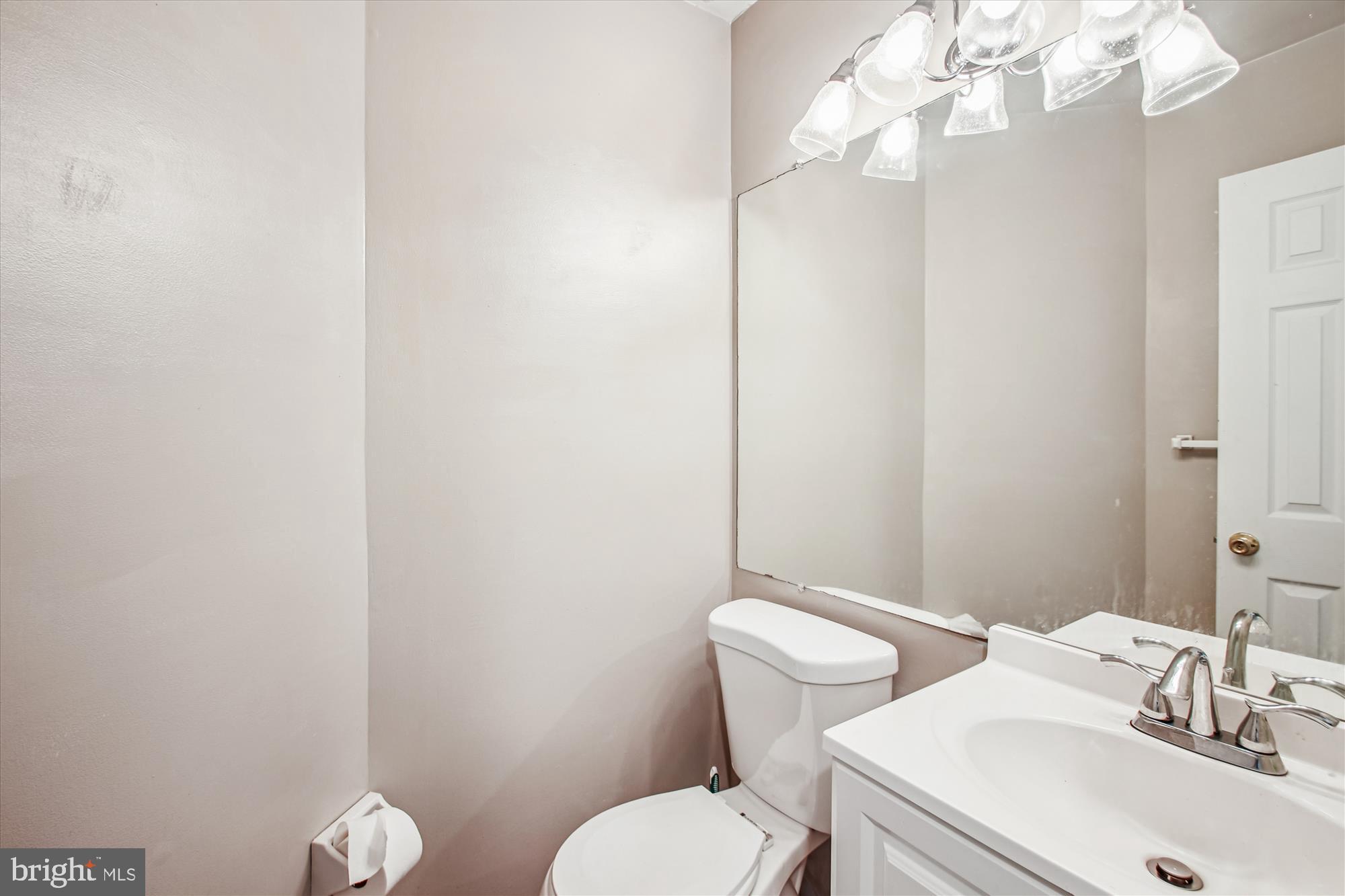 9469 Clocktower Lane Columbia, MD 21046 - Photo 11 of 28 a bathroom with a sink a toilet and a mirror