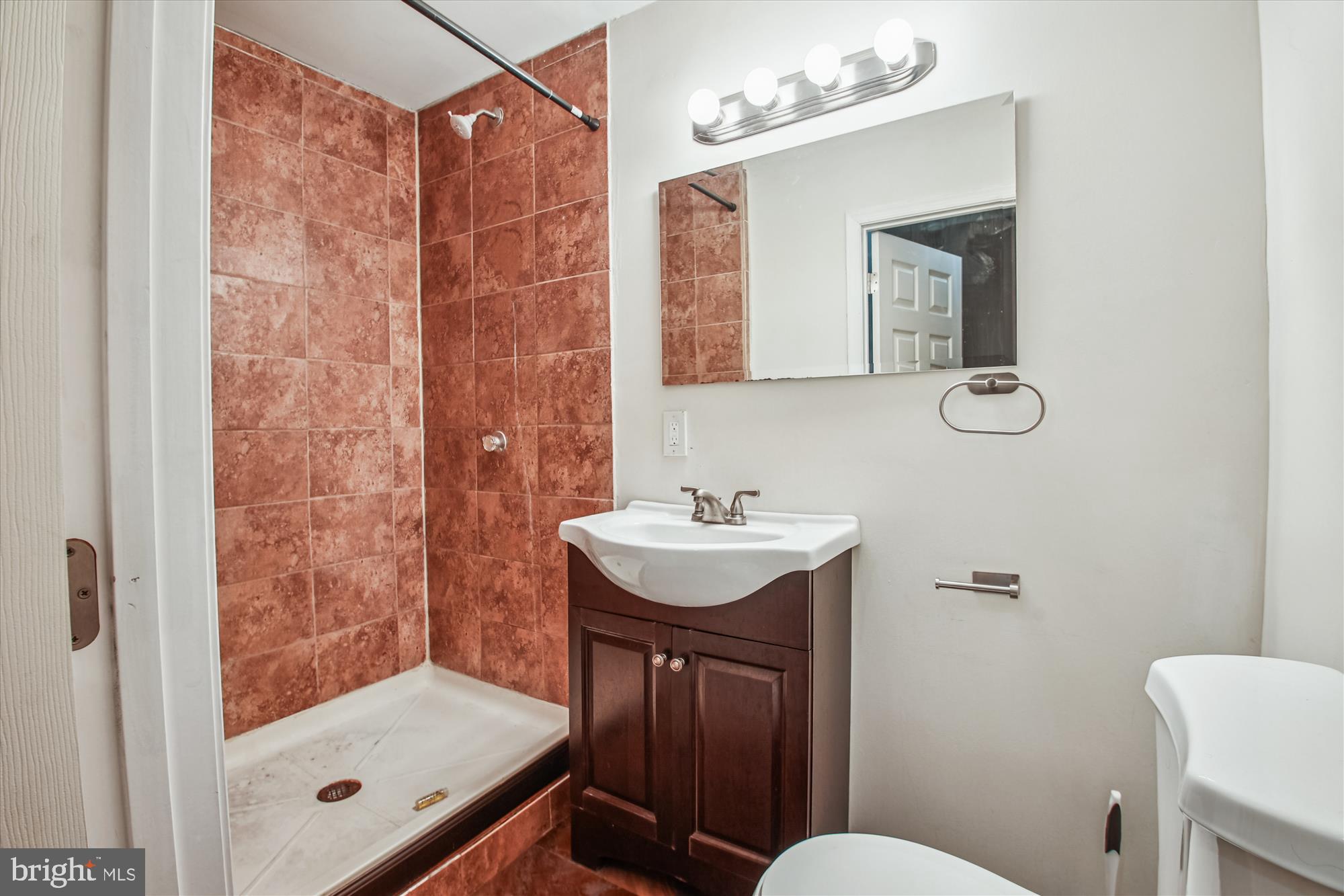 9469 Clocktower Lane Columbia, MD 21046 - Photo 22 of 28 a bathroom with a sink a toilet a mirror and shower