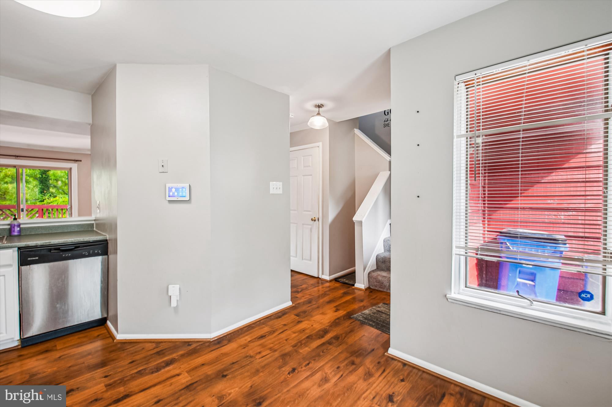 9469 Clocktower Lane Columbia, MD 21046 - Photo 5 of 28 a view of a kitchen with wooden floor and staircase