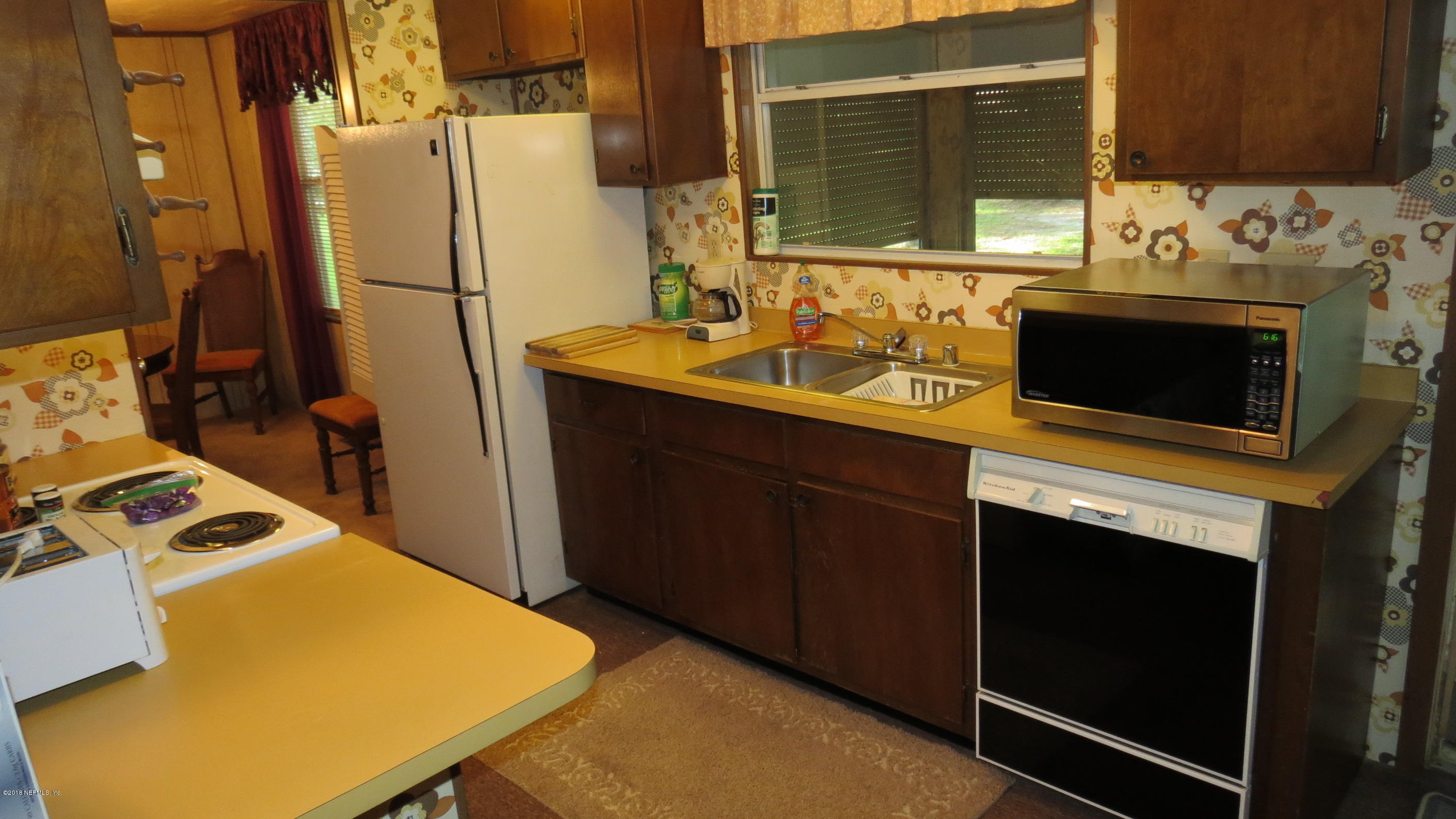 309 Whispering Pines Road Georgetown, FL 32139 - Photo 8 of 20 a kitchen with a sink stove and refrigerator