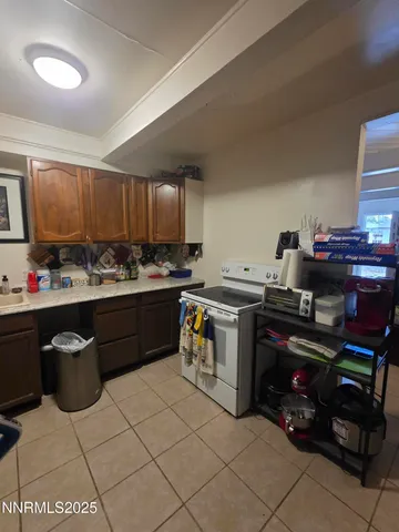 a kitchen with a stove a sink and a refrigerator