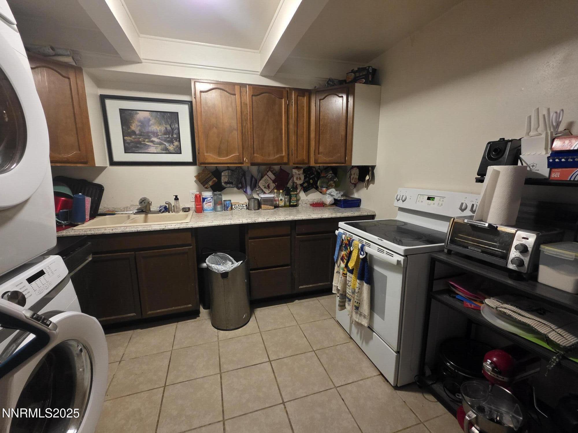 107 English Street Hawthorne, NV 89415 - Photo 9 of 21 a kitchen with a sink stove and cabinets