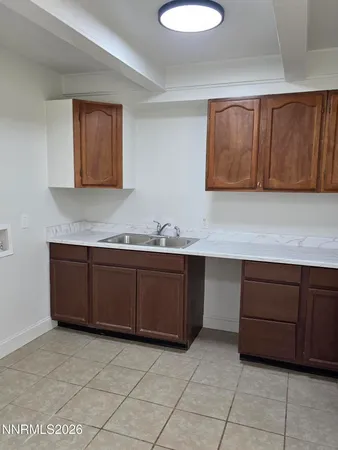 a view of kitchen with a sink a toilet and a window