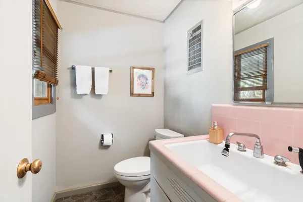 a bathroom with a sink a toilet and tub