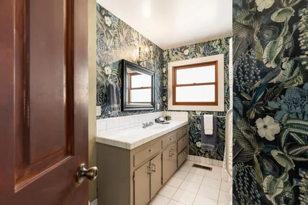 a bedroom with a bed and a large mirror