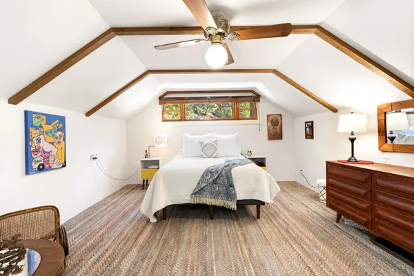 a bedroom with bed and wooden floor
