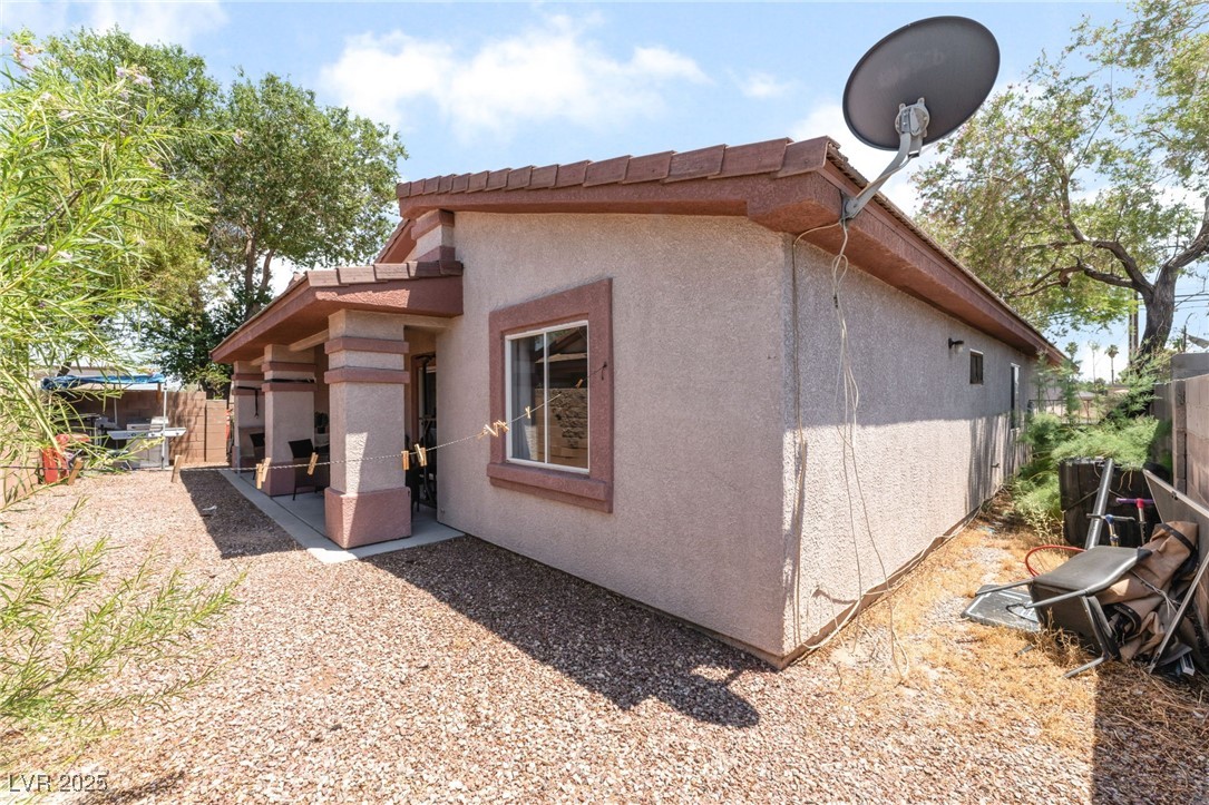 4656 East Desert Inn Road Las Vegas, NV 89121 - Photo 83 of 98 4652 E DI View of side of property featuring stucco siding and a patio