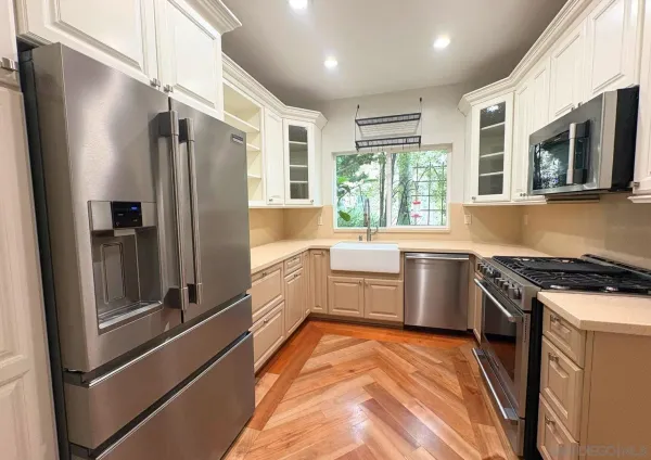 a kitchen with stainless steel appliances granite countertop a refrigerator and a sink