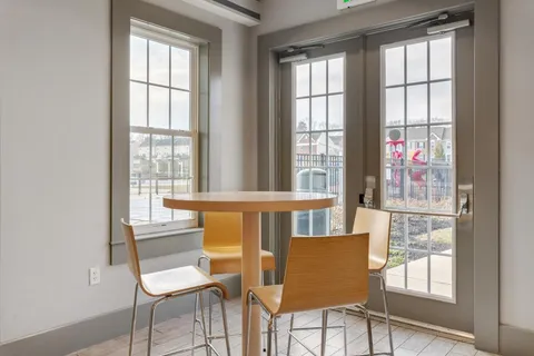 a view of a dining room with furniture and a window