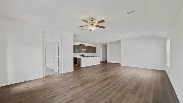 a kitchen with granite countertop cabinets stove top oven and microwave
