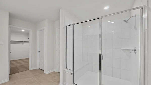 an empty room with closet and a ceiling fan