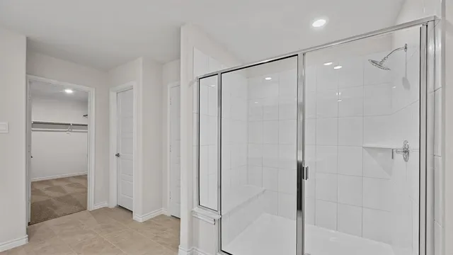 an empty room with closet and a ceiling fan