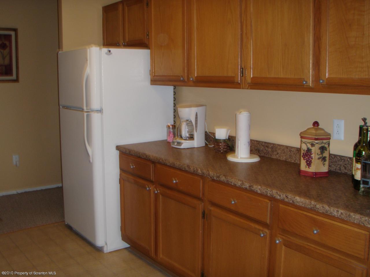 1206 Summit Pointe Scranton, PA 18508 - Photo 4 of 14 a kitchen with a refrigerator and cabinets