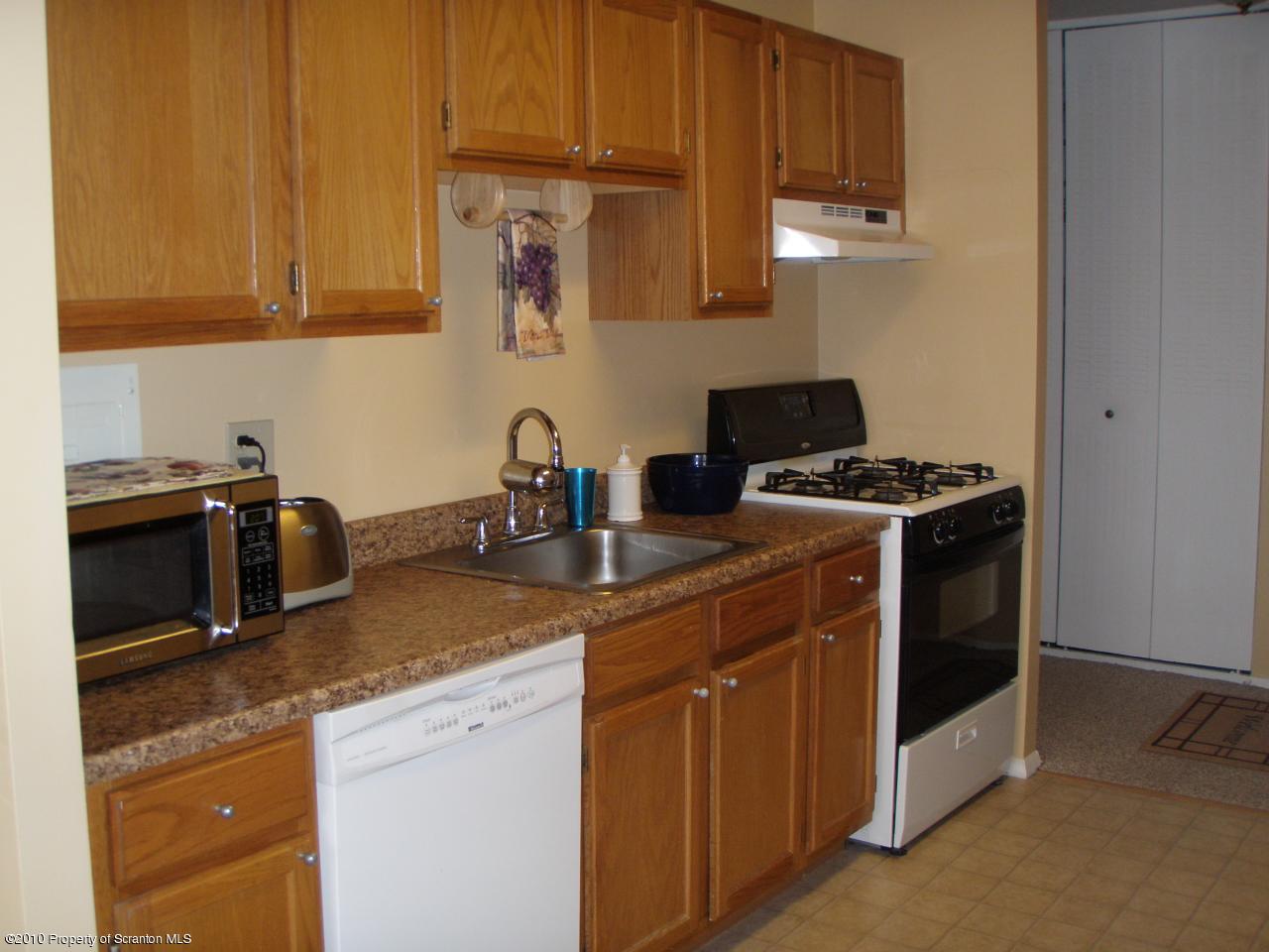 1206 Summit Pointe Scranton, PA 18508 - Photo 5 of 14 a kitchen with stainless steel appliances granite countertop a sink stove and microwave