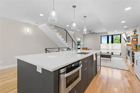 a kitchen with a sink a stove and chairs