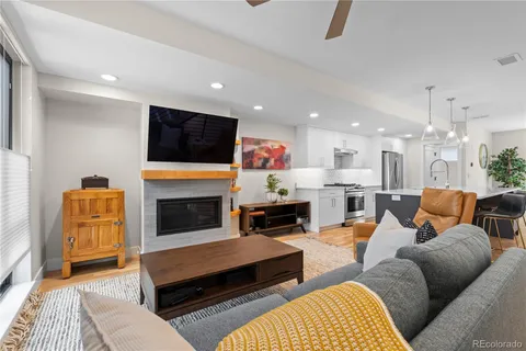 a living room with furniture fireplace and flat screen tv