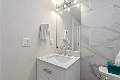a bathroom with a sink a toilet and a mirror