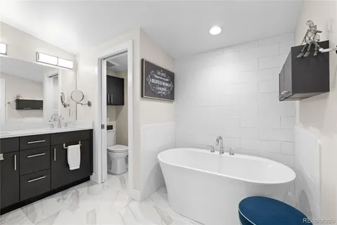 a spacious bathroom with a toilet a sink and mirror