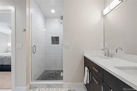 a bathroom with a sink a toilet a shower and a mirror