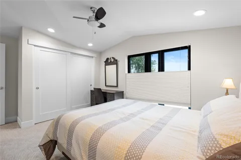 a bedroom with a large bed and a chandelier