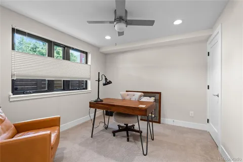 a view of a livingroom with furniture and a window
