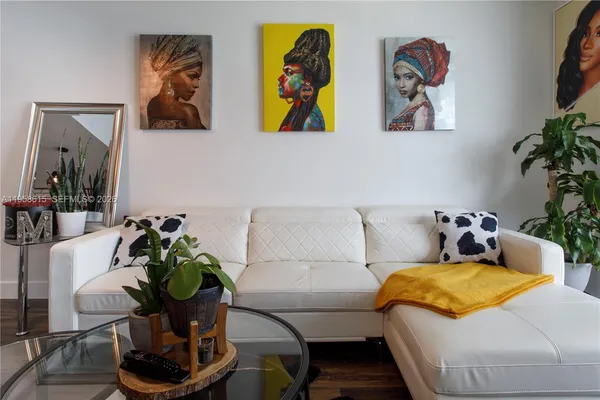 a living room with furniture and flowers