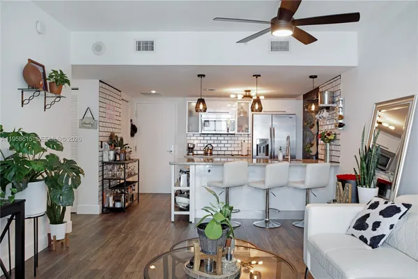 a view of a livingroom with furniture and a potted plant