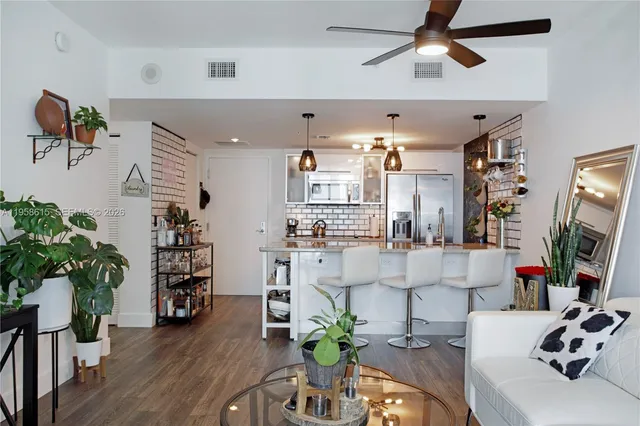 a view of a livingroom with furniture and a potted plant