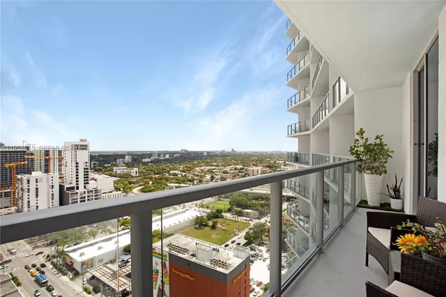 a view of a balcony with wooden floor and fence