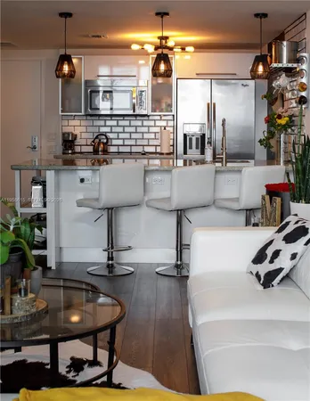 a kitchen with a sink and a refrigerator