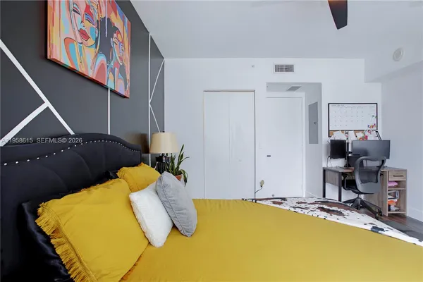 a bedroom with a bed and a flat screen tv