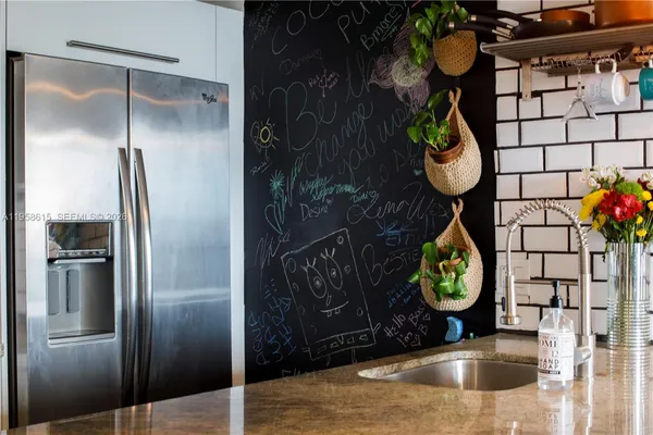 a kitchen with a refrigerator and a stove
